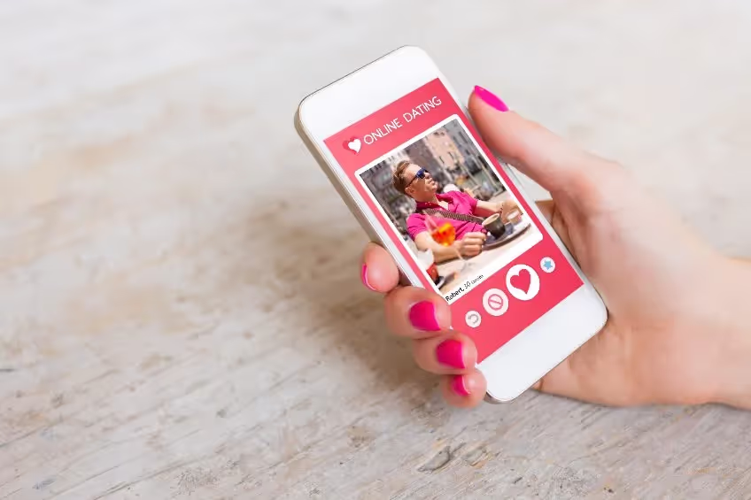 Smartphone screen displaying an online dating profile of a man named Robert, 30 years old, with buttons for disliking, liking, and other actions.